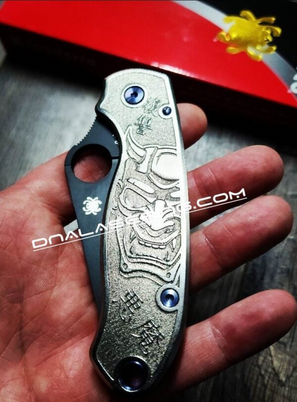 il_fullxfull.4673257411_rqtg-1.jpg Japanese Devil Mask - Spyderco PM3 TI - NEW Relief Engraving Style - Laser Engraved - Titanium Scales - EDC Gear - Knife Install Optional