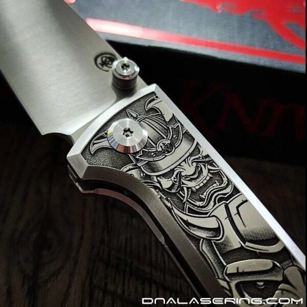 il_fullxfull.5953473129_rcwb.jpg Chaves Knives Relief Engraved RCK9 With Samurai Devil Mask Theme !! Titanium - M390 steel - COMPLETE KNIFE!! With Extra clip - New in box