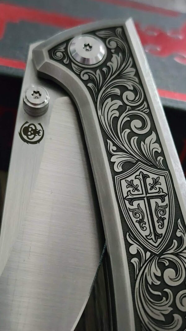 il_fullxfull.8012475322_6ggg.jpg Chaves Knives - Relief Engraved RCK9 - Titanium Scales -Knight’s Crest - M390 Steel - COMPLETE KNIFE!! With Extra Clip - New in Box