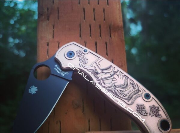 il_fullxfull.4168141541_3mwf.jpg Japanese Devil Mask - Spyderco PM3 - NEW Relief Engraving Style - Laser Engraved Copper PM3 Knife Scales - Flytanium - Knife Install Option